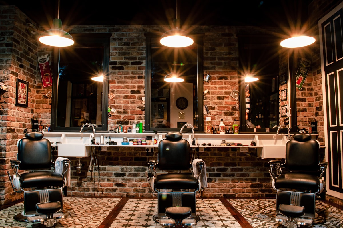 Barbershop interior with barber chairs, mirrors, and stations ready for clients